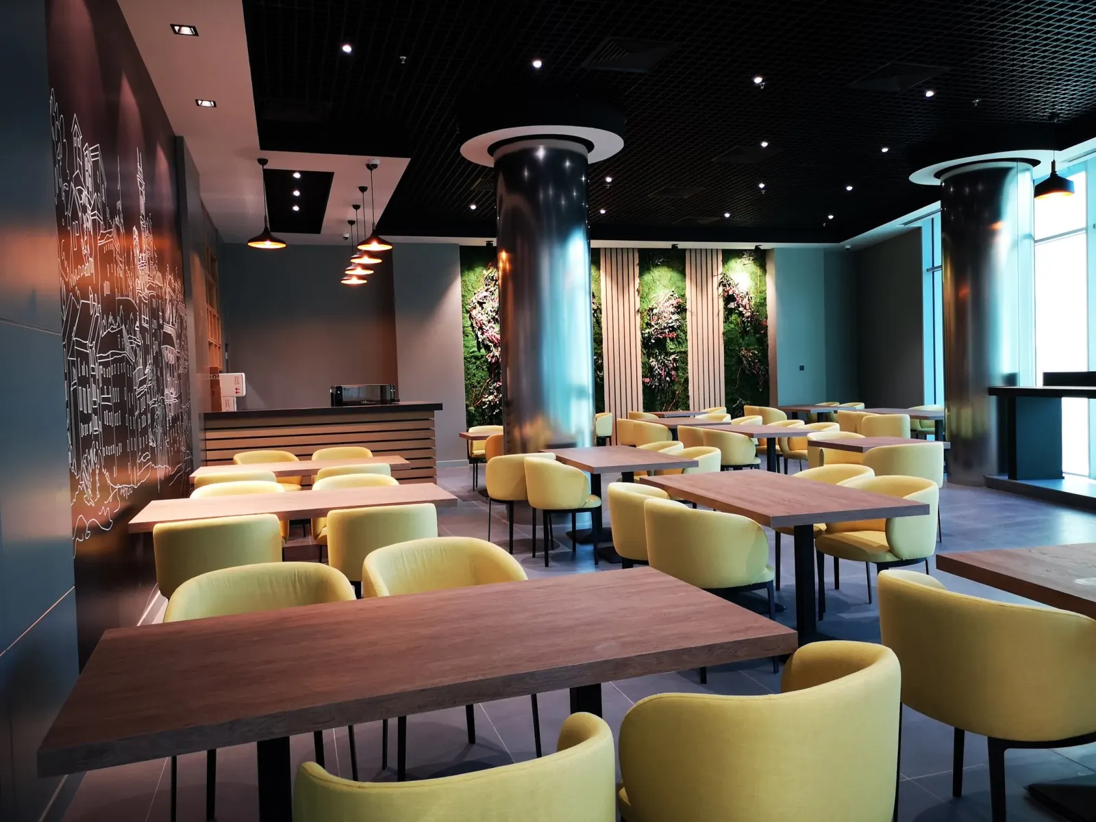 Confidence Group — Business Center Interior — Modern employee cafeteria and dining hall with acoustic ceiling baffles and communal tables